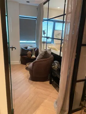 a living room with a couch and a window at Holiday apartment south Norway in Lii