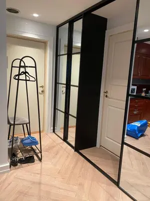 a mirror in a room with a chair and a ladder at Holiday apartment south Norway in Lii