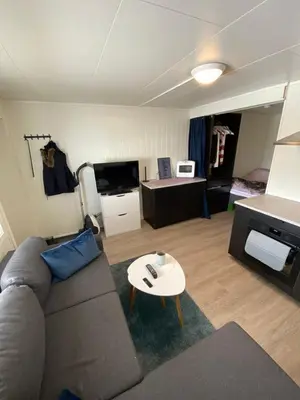 a living room with a couch and a table at Nice little studio centrally located in Lii