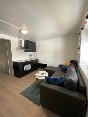 a living room with a couch and a table at Nice little studio centrally located in Lii
