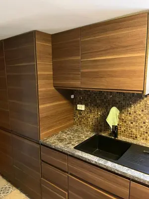 a kitchen with wooden cabinets and a sink at Villa chaimae in Lii