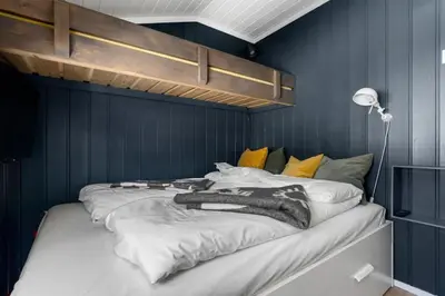 a bedroom with a large bed with blue walls at Trysilfjell 720 by Vacation Trysil in Trysil