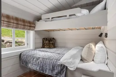 a small bedroom with a bed and a window at Trysilfjell Nord 1105C - by Vacation Trysil in Trysil