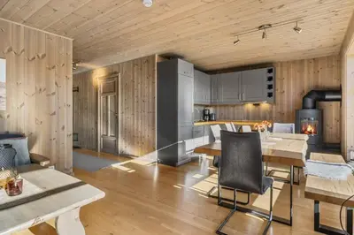 a kitchen and living room with a table and chairs at Trysilfjell 24 by Vacation Trysil in Trysil