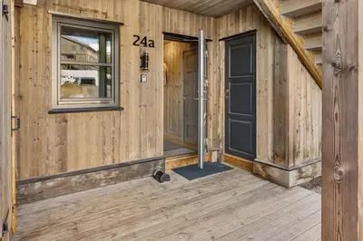 a wooden cabin with a door and a window at Trysilfjell 24 by Vacation Trysil in Trysil
