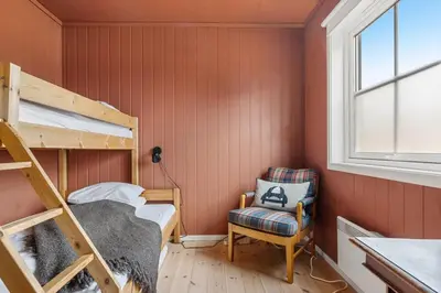 a small room with a bunk bed and a chair at Trysilfjell 782 by Vacation Trysil in Trysil