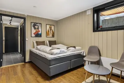 a bedroom with a bed and two chairs in it at Trysilfjell 33 by Vacation Trysil in Trysil