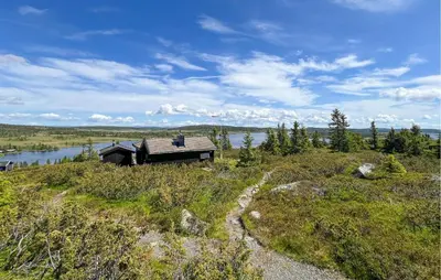 a house on top of a hill with a body of water at 3 Bedroom Stunning Home In Lillehammer in Lillehammer