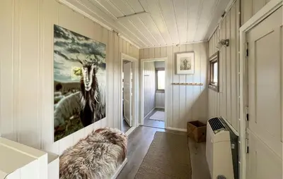 a hallway with a couch and a painting on the wall at 3 Bedroom Stunning Home In Lillehammer in Lillehammer