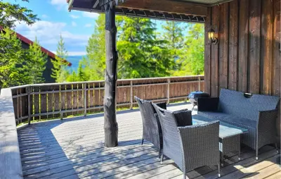 a deck with chairs and a table on a porch at 2 Bedroom Nice Home In Hafjell in Hafjell