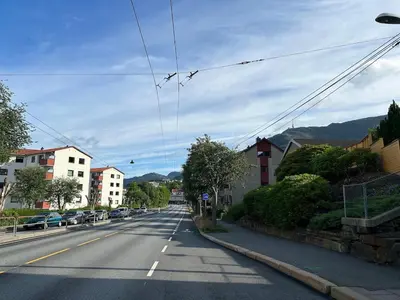 an empty street in a town with buildings and cars at Family-friendly townhouse on Landås in Lii