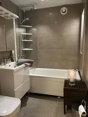 a bathroom with a tub and a toilet and a sink at Family-friendly townhouse on Landås in Lii