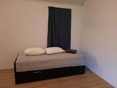 a bed with two pillows on it in a room at Holiday Home Garnås in Nesbyen