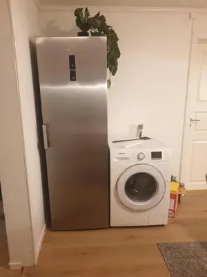 a refrigerator next to a washing machine in a room at Holiday Home Garnås in Nesbyen