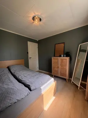 a bedroom with a bed and a dresser and a mirror at Martine's home in Lii