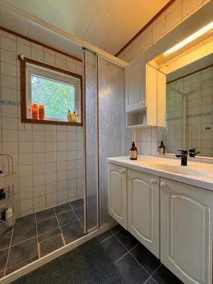 a bathroom with a sink and a shower at Martine's home in Lii