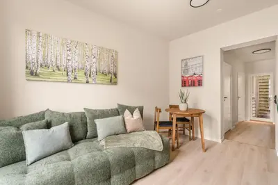 a living room with a green couch and a table at City Apartment I Cozy with Perfect Location in Bergen