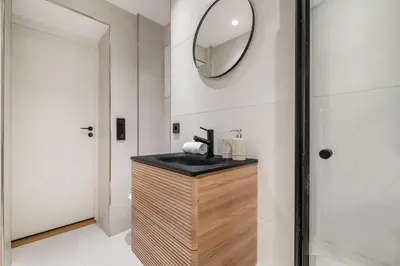 a bathroom with a sink and a mirror on the wall at City Apartment I Cozy with Perfect Location in Bergen