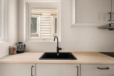 a kitchen counter with a sink and a window at City Apartment I Cozy with Perfect Location in Bergen