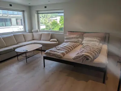 a living room with a couch and a table at Apartment in the middle of the city center in a quiet street in Stryn