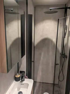 a bathroom with a sink and a shower at Apartment in the middle of the city center in a quiet street in Stryn