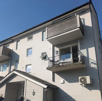 an apartment building with a balcony and a window at Apartment in the middle of the city center in a quiet street in Stryn