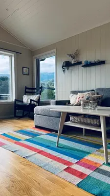 a living room with a couch and a coffee table at Cabin by the lake with 3 bedrooms in Kvam