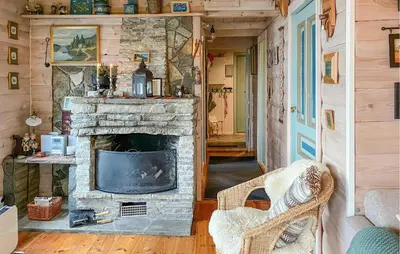 a living room with a stone fireplace in a house at Stunning Home In Lavik in Lavik