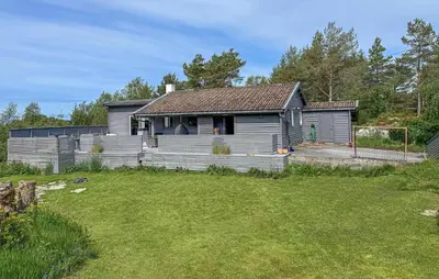 a house with a fence and a yard at 3 Bedroom Gorgeous Home In Kolbeinsvik in Kolbeinsvik