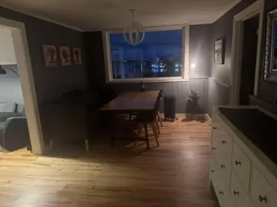 a dining room with a table and a window at KSU Topleiligheten in Kristiansund