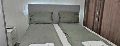 a bed with two pillows on top of it at Lakeside apartment in Stryn