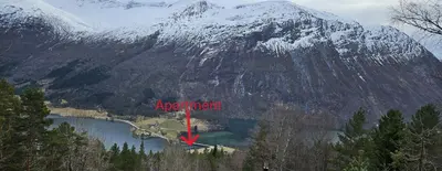 an aerial view of a mountain and a lake at Lakeside apartment in Stryn