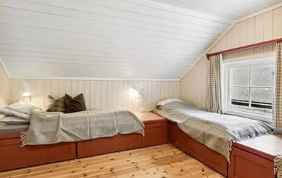 a bedroom with two beds and a window at Cabin with ski in-out in Sør-Fron