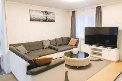 a living room with a couch and a flat screen tv at Apartment in Bergen in Bergen