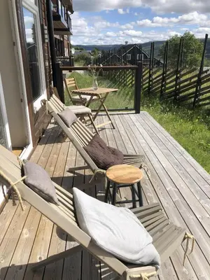 a porch with two chairs and a table and a table at Stay in central Geilo, 3 bedrooms, linen and towels included in Geilo