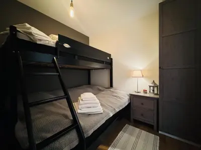 a bedroom with a bunk bed with a ladder at Stay in central Geilo, 3 bedrooms, linen and towels included in Geilo