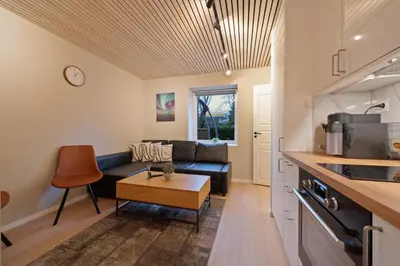 a living room with a couch and a table at EasyStay Nesttun -Free Parking-Buss Nearby - in Bergen