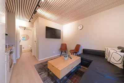 a living room with a couch and a table at EasyStay Nesttun -Free Parking-Buss Nearby - in Bergen