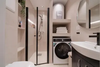 a bathroom with a washing machine and a sink at EasyStay Nesttun -Free Parking-Buss Nearby - in Bergen