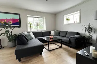 a living room with a couch and a table at Nordic Villa Retreat in Ålesund