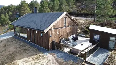 an overhead view of a large wooden building with a sink at Cabin at the end of Skardsøya towards the sea - boat in Bukta