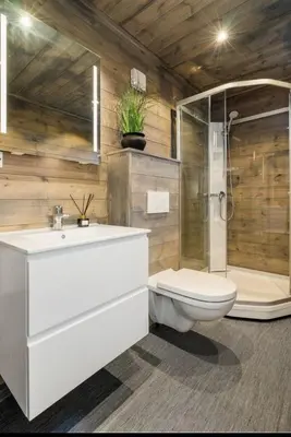 a bathroom with a sink and a toilet and a shower at Cabin at the end of Skardsøya towards the sea - boat in Bukta