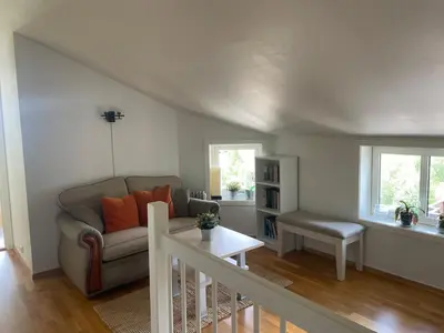 a living room with a couch and a table at Toppleilighet Midt I Beitostølen in Beitostøl