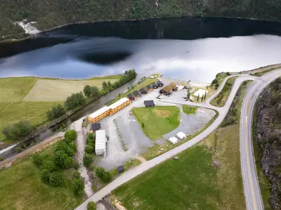 an aerial view of a farm with a lake at Standard Hytte in Fjæra