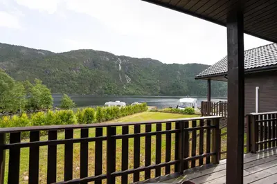 a view of a river from a porch of a house at Standard Hytte in Fjæra