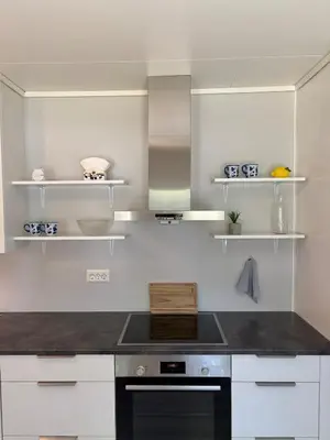 a kitchen with white cabinets and a stove top oven at House in Nordfjord, with 4 bedrooms in Nordfjordeid