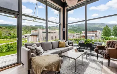 a living room with a couch and large windows at Lovely Home In Ål With House Sea View in Ål
