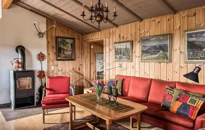 a living room with a red couch and a table at Amazing Home In Tunhovd With Sauna in Tunhovd