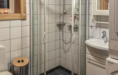 a bathroom with a shower with a toilet and a sink at Amazing Home In Tunhovd With Sauna in Tunhovd