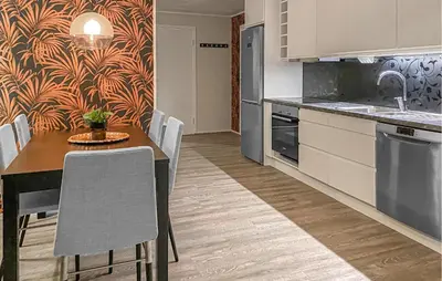 a kitchen with a table and chairs in a room at Amazing Apartment In Bjorli With Sauna in Bjorli